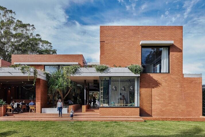 Modern red-brick building housing boutique Gold Coast retailers and cafes at Cornerstone Stores, Currumbin—offering a stylish coastal shopping experience.